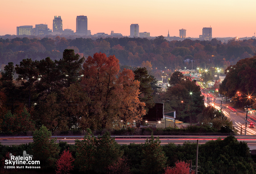 Autumn landscape with downtown Raleigh looming over Wake Forest Road and the I-440 Beltline.