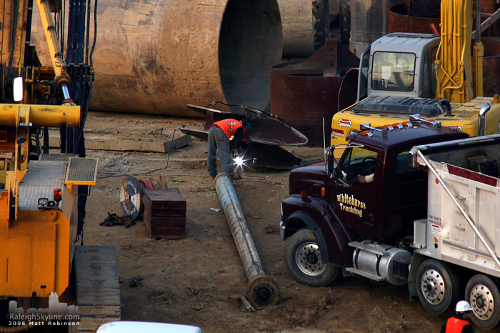 A construction worker welds at the site of the Raleigh convention center.