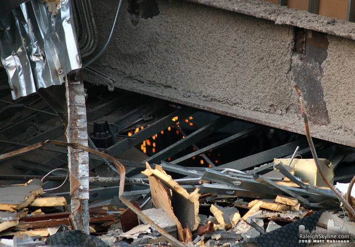 Sparks fly inside the debris of the old Raleigh convention center.