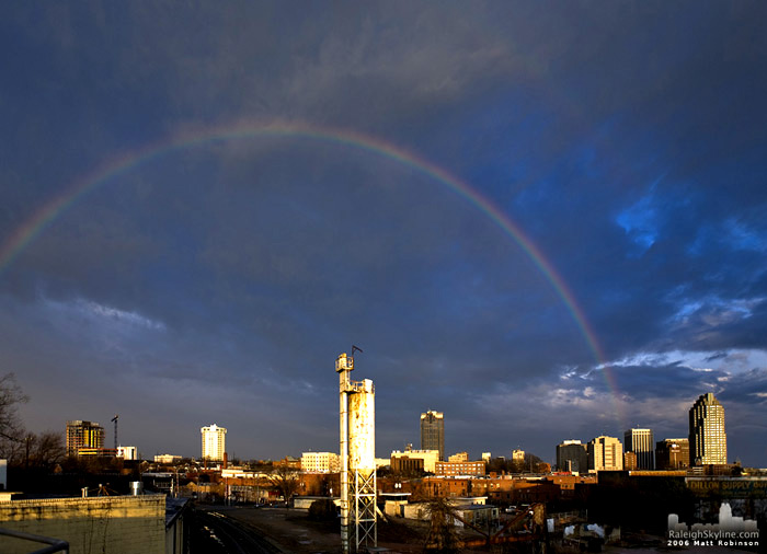 A rainbow archs across the sky over Downtown Raleigh.