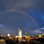 A rainbow archs across the sky over Downtown Raleigh.