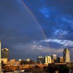 A rainbow cascades down and rests on downtown Raleigh.