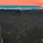 The rising sun and a church steeple.