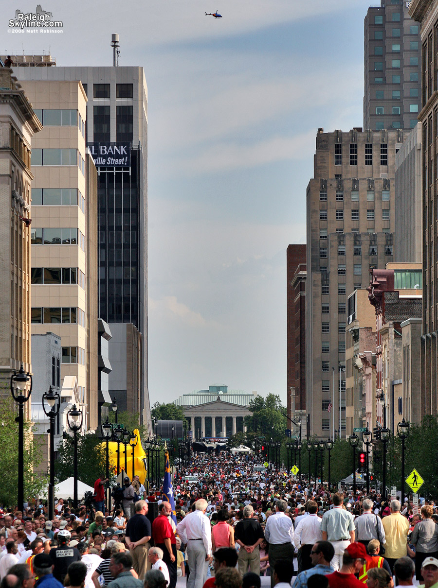 A news helicopter watches over a large crowd packing the brand new Fayetteville Street while Mayor Meeker spoke.