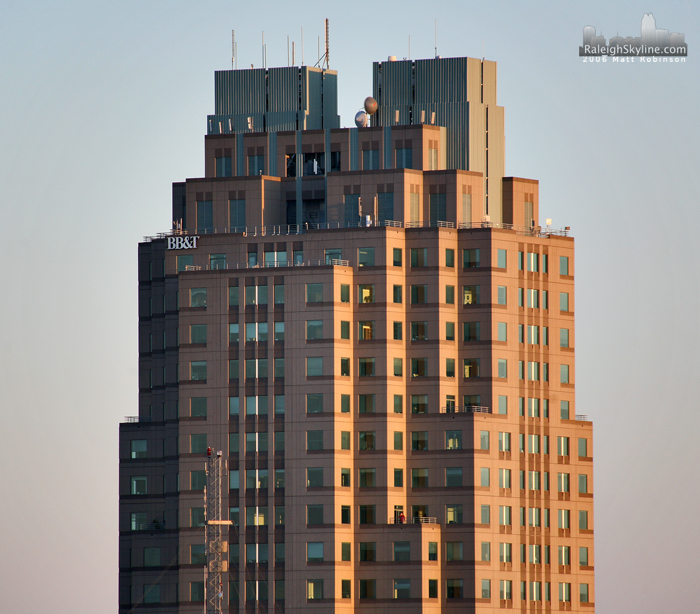 Man takes a break on a balcony of Two Hannover Square in Downtown Raleigh.