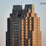 Man takes a break on a balcony of Two Hannover Square in Downtown Raleigh.