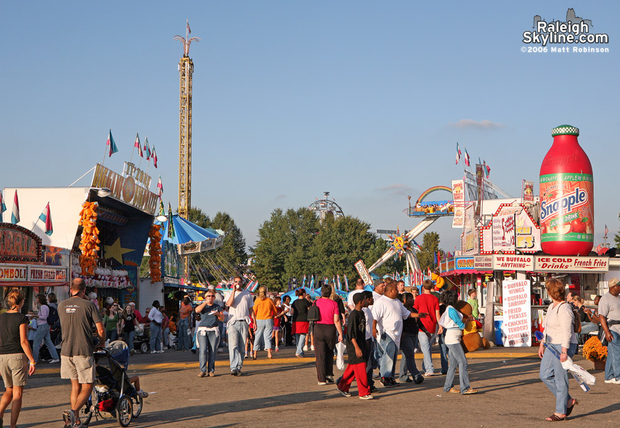 People walk the fairgrounds searching for a place to sit down.