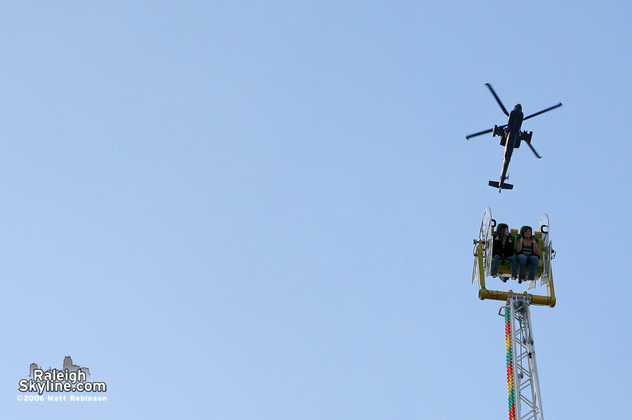 Riders visit an Apache(?) military helicopter.