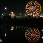 Night time ferris wheel reflection.