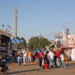 People walk the fairgrounds searching for a place to sit down.