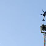 Riders visit an Apache(?) military helicopter.