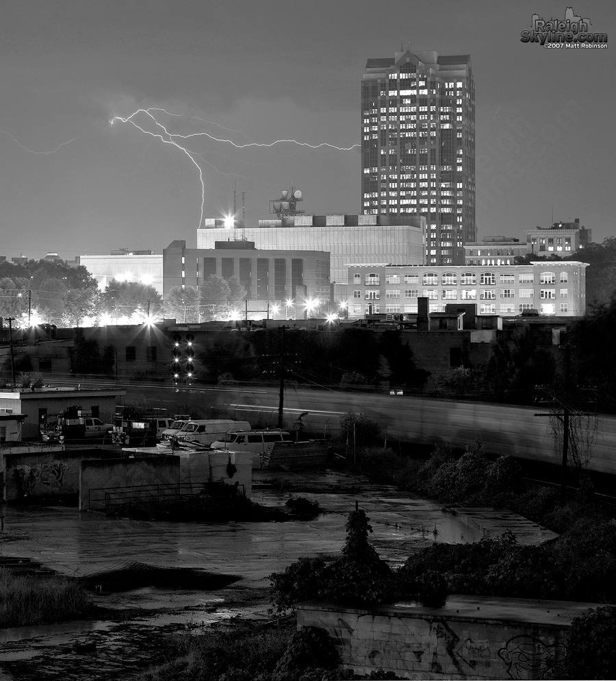 As a train rolls through downtown, lightning makes an appearance adjacent to Wachovia Capital Center.