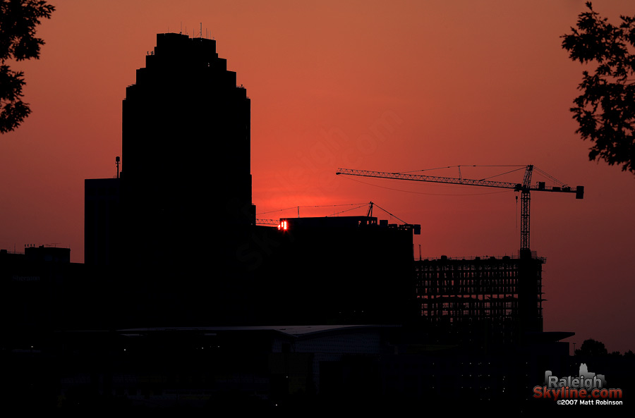 The rising sun peeks into view over downtown.