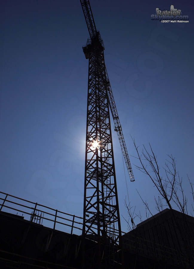 Sun peeks through the tower crane constructing the RBC Plaza Condos.