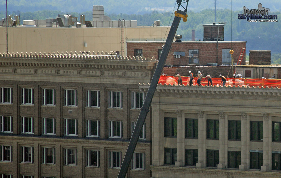 Crews and crane work upon...something?