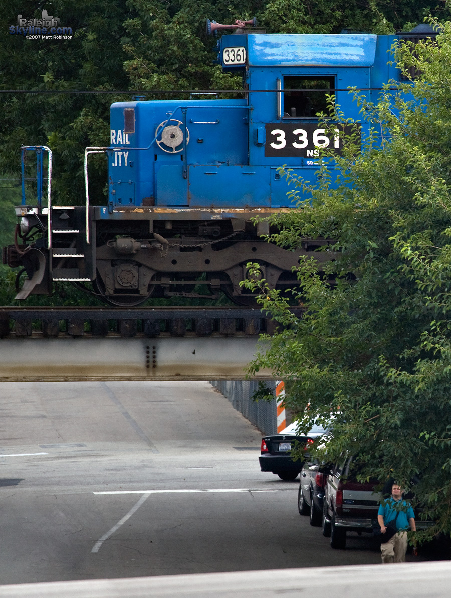 Old Conrail engine hovers over pedestrian.