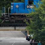 Old Conrail engine hovers over pedestrian.