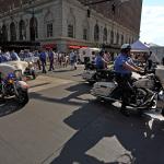 Police begin to clear the road for the parade.