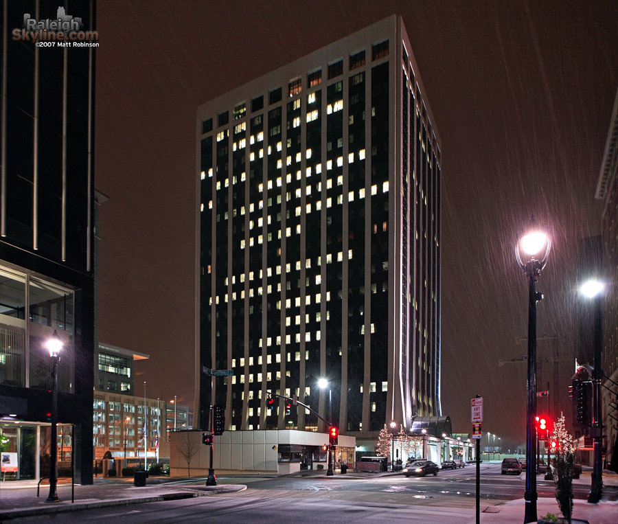 Snow falls in front of One Progress Plaza.