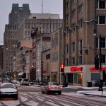 Snow lightly covers cars, sidewalks and Fayetteville Street in Downtown Raleigh.