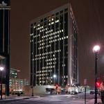 Snow falls in front of One Progress Plaza.