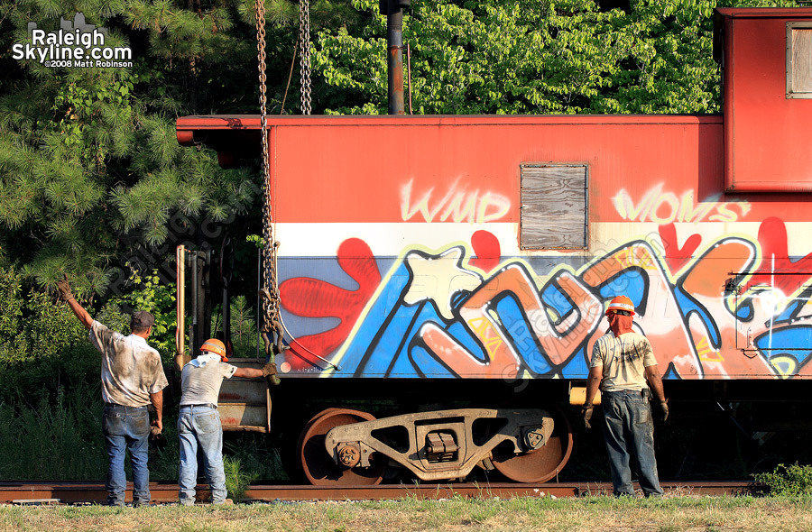 The mysterious cabooses along Capital Boulevard in Raleigh are placed onto rail.