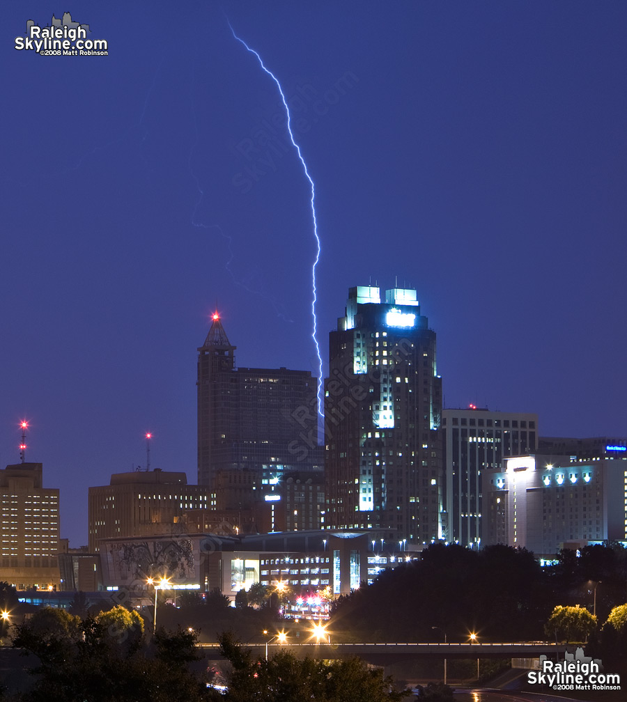 A lightning bolt squeezes between RBC Plaza and Two Hannover Square.