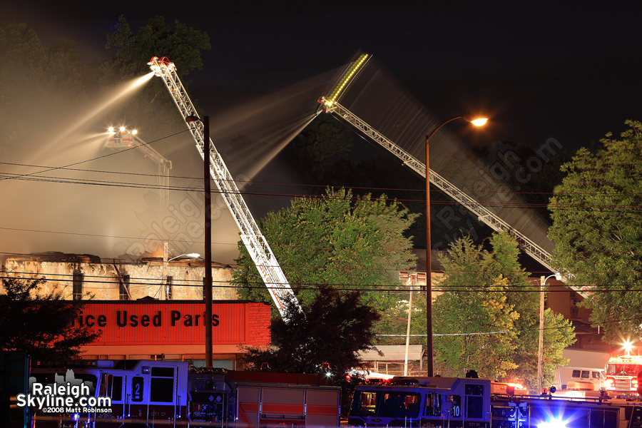 Raleigh Firefighters stream water on 'Hunter and Co. Painterswork'.