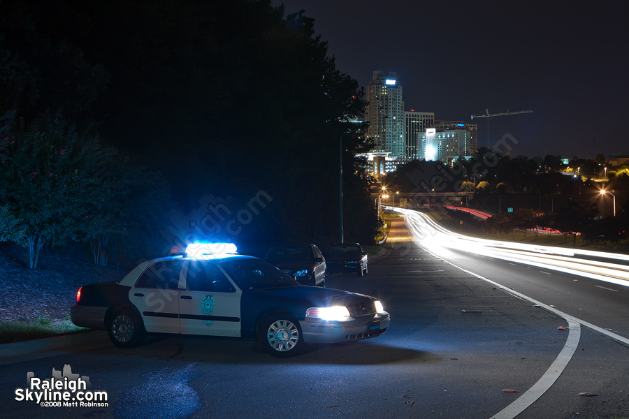 Raleigh Police Car diverts cars away from scene of the fire.