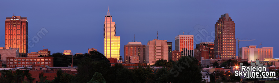 Golden sky reflects on downtown Raleigh buildings.