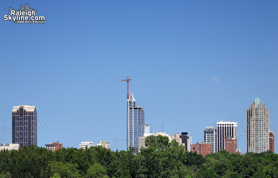 Moon rises over downtown on a clear day