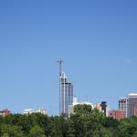 Moon rises over downtown on a clear day