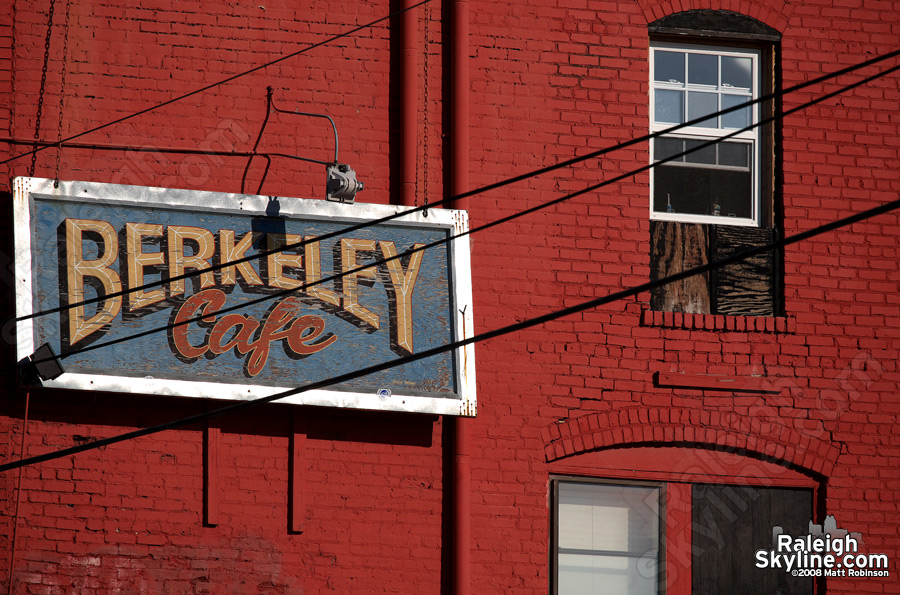 Berkeley Cafe sign and a toothbrush in the window.