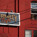 Berkeley Cafe sign and a toothbrush in the window.