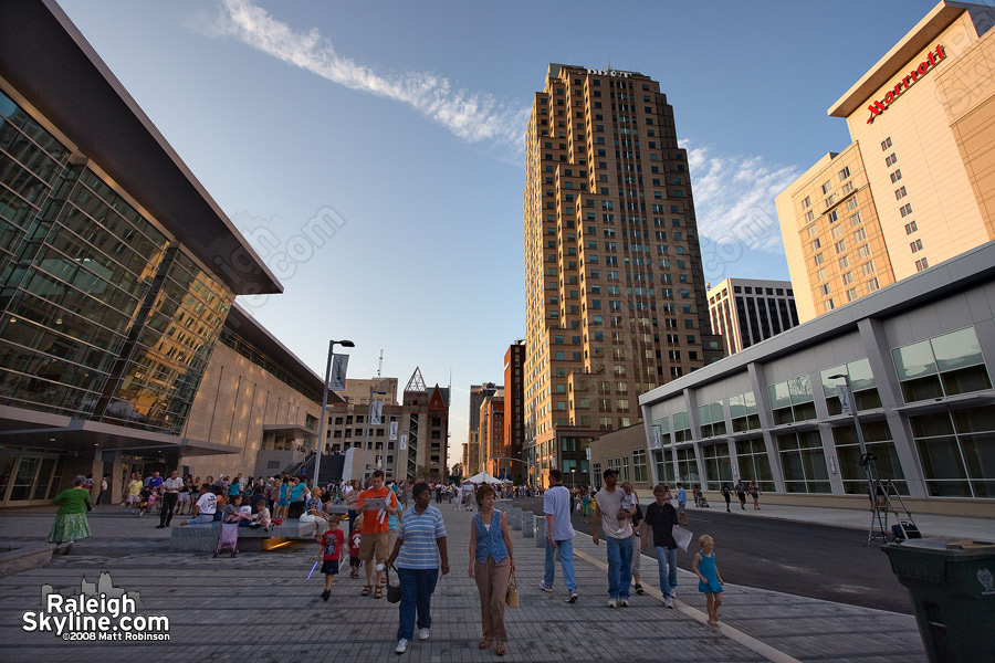 People walk along Salisbury Street checking out the new Raleigh Convention Center.