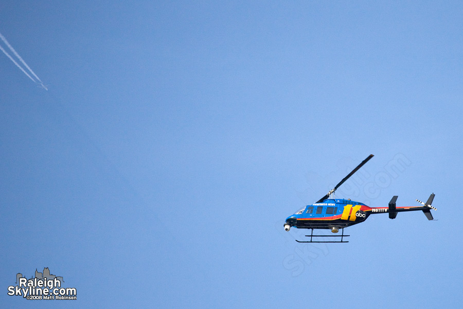 ABC 11 Helicopter and commercial jet with a sinlgle crepuscular ray