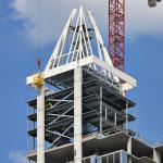 Welder works atop the Raleigh Skyline