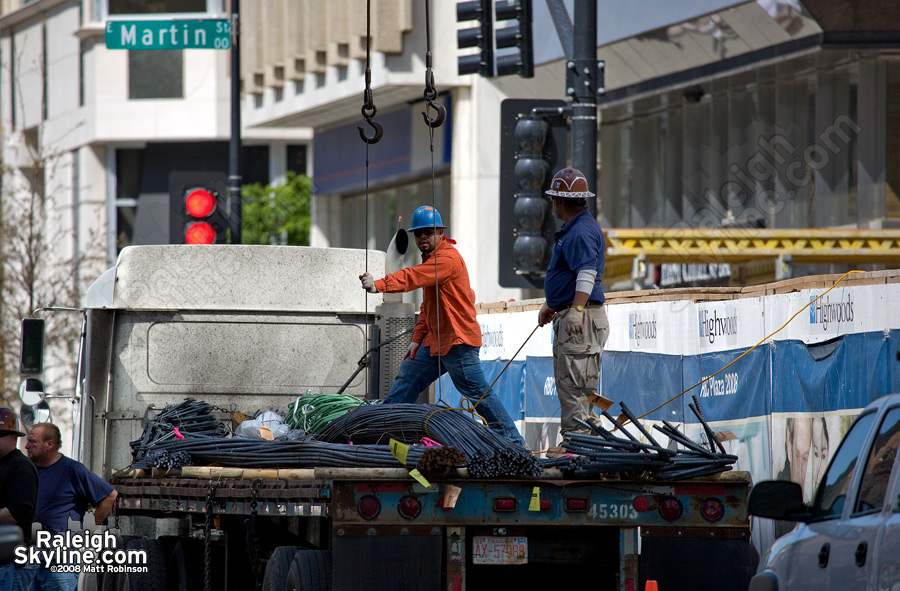 Construction workers prepare to hoist giant licorice pieces