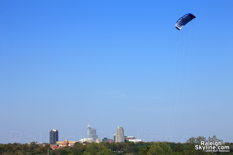 A kite flies high above the city of Raleigh