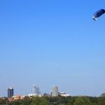 A kite flies high above the city of Raleigh