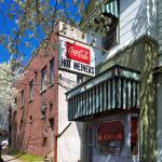 Raleigh icon The Roast Grill framed in a Bradford Pear