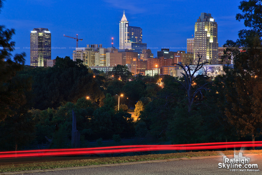 Night time city skyline from Umstead Drive with car traffic, Raleigh, NC