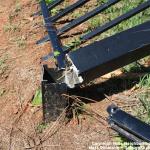 Bent metal fence around Caraleigh Mills