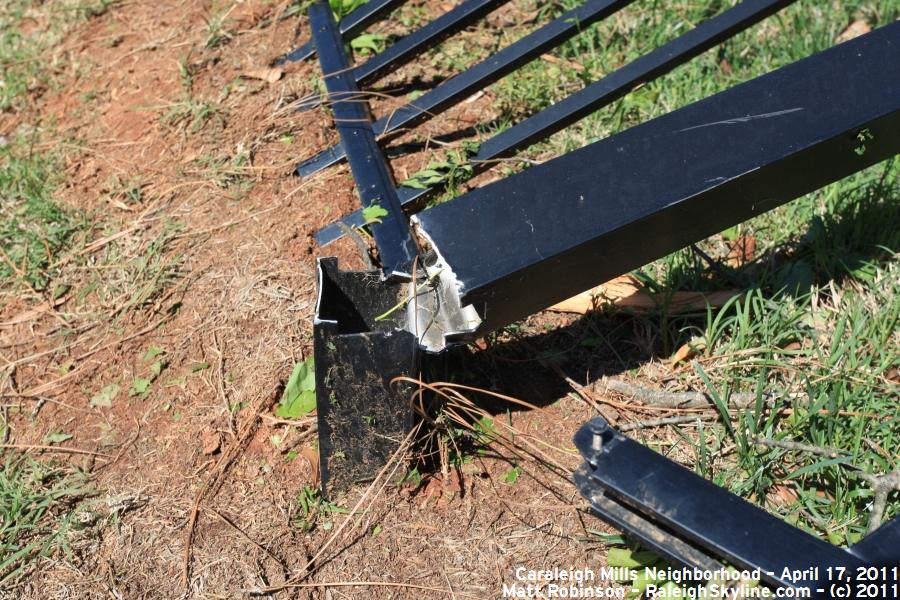 Bent metal fence around Caraleigh Mills