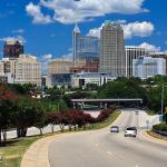 Blue sky and clouds with the Raleigh skyline