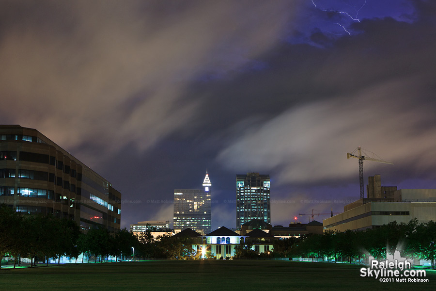 Lightning peeks over various layers of clouds