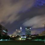 Lightning peeks over various layers of clouds