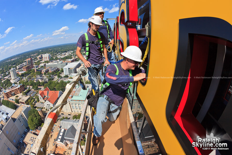 Workers from Atlas Signs complete wiring for illumination of the Wells Fargo signage