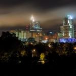 Low clouds rush past downtown buildings