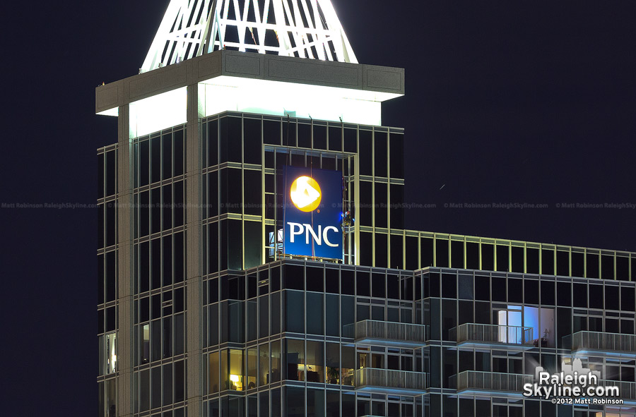 Work continues at night on the PNC sign